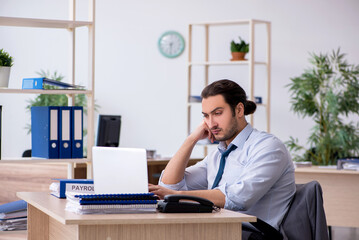 Young male bookkeeper working in the office