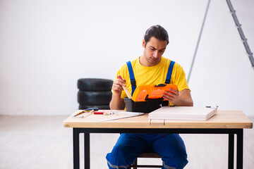 Young male carpenter working indoors