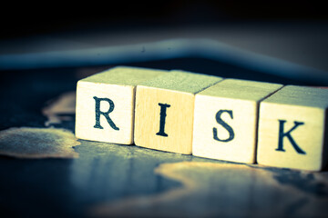 Wooden cube block showing ”RISK” wording
