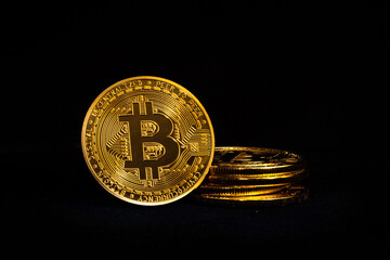 Bitcoin cryptocurrency coin stacked on isolated black background