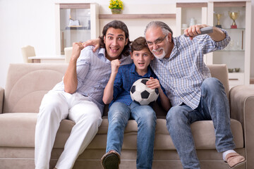 Boy and his father and his grandfother indoor