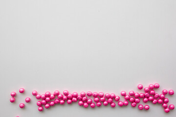 round pink candies on a white background