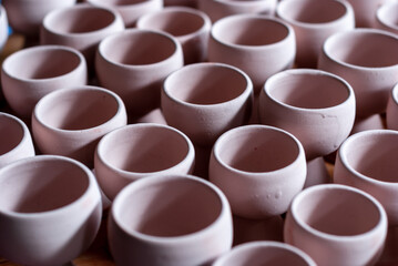 Freshly molded clay kitchenwares on display and sold in a pottery workshop