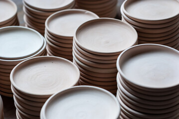 Freshly molded clay kitchenwares on display and sold in a pottery workshop