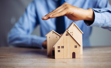 Insurance house, and family health live concept. The insurance agent presents  the ้hands...