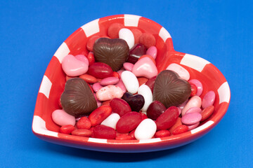 Some candy and chocolat in an heart shape bowl for Valentine's day