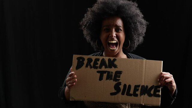 a loud scream by a female black lifes matter protester holding a cardboard sign is breaking the silence