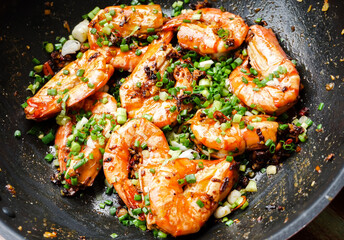 Close up Thai stir fried prawns with chillies salt and garlic on pan, Thai spicy seafood restaurant menu