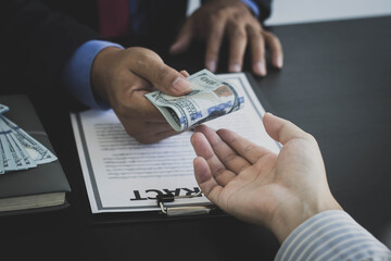 The businessman is returning the bribe to a partner company. Refusing to accept a bribe from a...