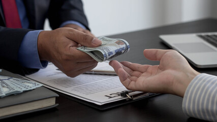 The businessman is returning the bribe to a partner company. Refusing to accept a bribe from a...