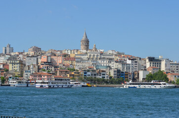 Naklejka premium Istanbul cityscape with Galata Tower and passenger boats - Istanbul, Turkey