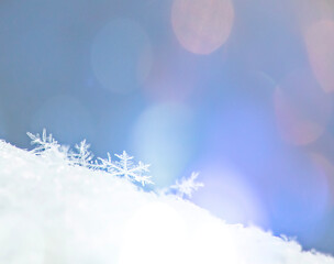 Fototapeta na wymiar Christmas background with a decorative snowflake on brilliant snow