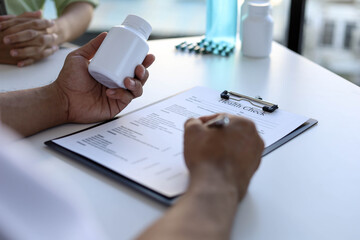 The doctor is checking the medication in the examination room. Check medical drugs. Disease treatment concept.