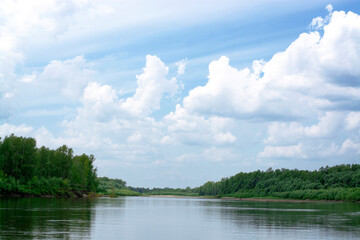 Obraz na płótnie Canvas Blue sky on a calm summer day. Bend of the river in Siberia, forest near water