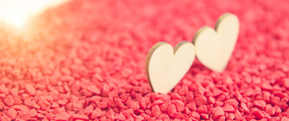 Fototapeta premium Close-up two hearts for love symbol on a red sand background. Concept the day of love 14 February happy valentine's day.