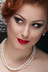 Portrait of gorgeous bright young woman with pearl necklace