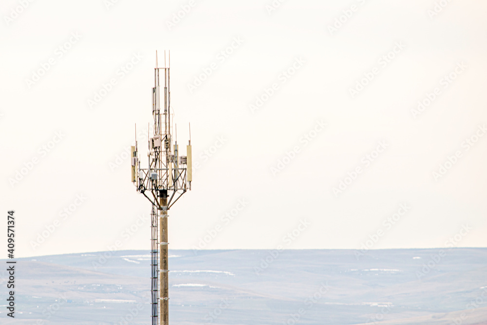 Wall mural cell tower on the background of the autumn gray sky