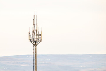 cell tower on the background of the autumn gray sky