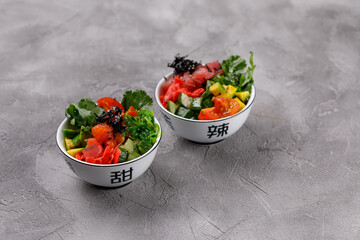 Hawaiian food platter in bowls on gray background. Pan-Asian cuisine to go or delivery in a container. Close-up