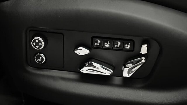 Driver's seat adjustment buttons. Closeup shot