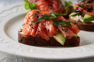 Tasty homemade sandwich with salmon ,greens and avocado