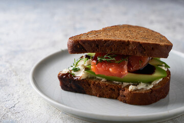 Tasty homemade sandwich with salmon ,greens and avocado