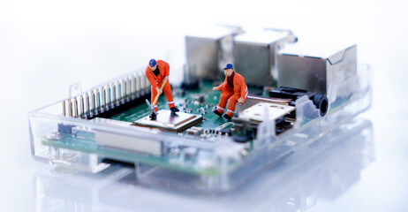 Miniature people : engineer finding and fixed of the problem on mainboard computer : finding and fixed concept.