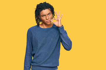 Young african american man wearing casual winter sweater mouth and lips shut as zip with fingers....