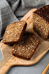 Closeup on sliced rye whole grain bread with seeds on the wooden board