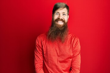 Redhead man with long beard wearing casual clothes with a happy and cool smile on face. lucky person.