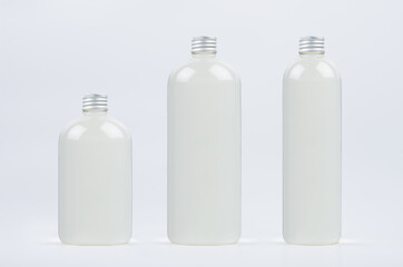 Set of different size plastic tall, low and thick bottles with water, silver cap mockup on white background, template.