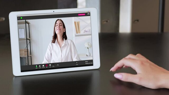 Video chat. Digital meeting. Online interview. Remote work. Excited woman job applicant speaking laughing on tablet screen to annoyed female HR manager tapping fingers on desk at modern workplace.