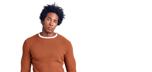 Fototapeta premium Handsome african american man with afro hair wearing casual clothes relaxed with serious expression on face. simple and natural looking at the camera.