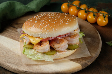 Burger with curves on a wooden background