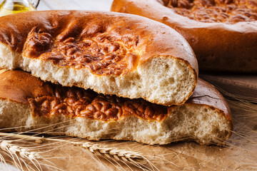 Horizontal closeup on broken fresh baked onion flat bread