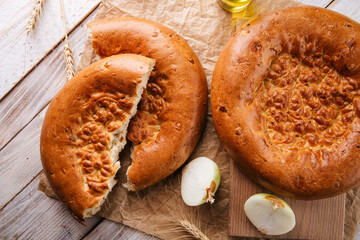 Horizontal top view on broken fresh baked onion flat bread