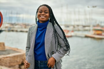 Young african american businesswoman smiling happy standing at the port.