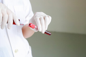 a nurse push the blood into the tube.