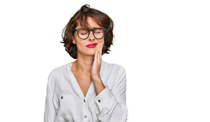 Fototapeta premium Young hispanic woman wearing business style and glasses touching mouth with hand with painful expression because of toothache or dental illness on teeth. dentist