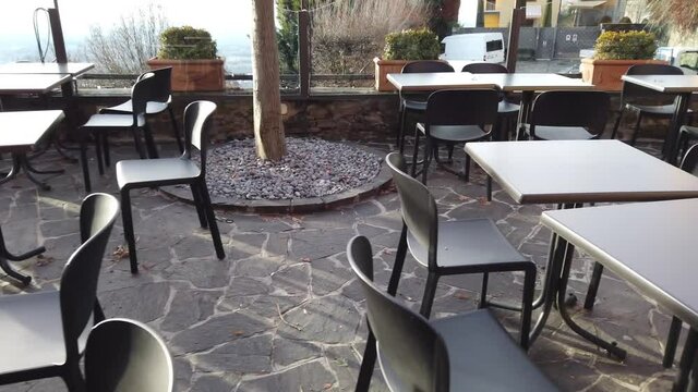 Bergamo, Italy. Empty bar tables due to the Covid-19 or Coronavirus pandemic. Light lockdown time. Bars and restaurants closed due to the absence of tourists. Desolation and sadness for empty city