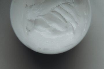 White moisturizing cream in a big open jar.