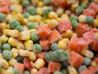 Colorful frosted vegetables carrot, corn and peas in heap