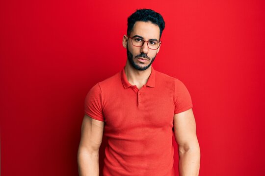 Young hispanic man wearing casual clothes and glasses depressed and worry for distress, crying angry and afraid. sad expression.