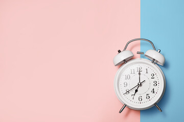 White clock alarm in vintage style on blue pink background with place for text