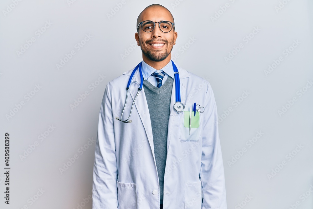 Canvas Prints Hispanic adult man wearing doctor uniform and stethoscope with a happy and cool smile on face. lucky person.