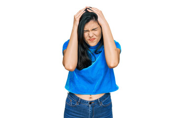 Young hispanic woman wearing casual clothes suffering from headache desperate and stressed because pain and migraine. hands on head.