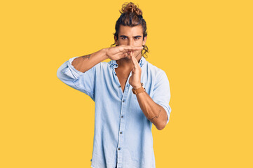 Young hispanic man wearing summer style doing time out gesture with hands, frustrated and serious...