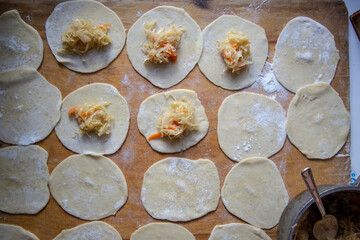 Fototapeta na wymiar dumplings with sauerkraut. Cooking process