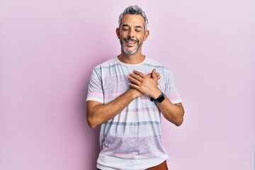 Middle age grey-haired man wearing casual clothes smiling with hands on chest with closed eyes and grateful gesture on face. health concept.