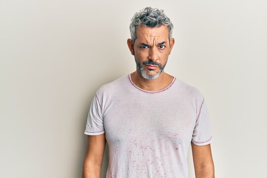 Middle age grey-haired man wearing casual clothes skeptic and nervous, frowning upset because of problem. negative person.